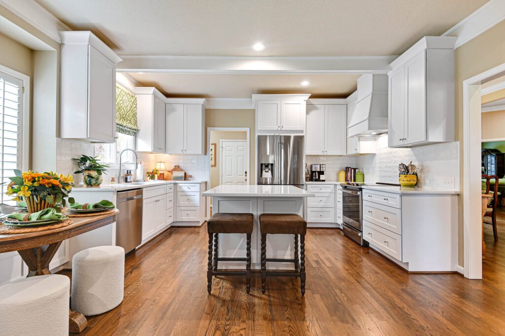 White shaker kitchen cabinets with island and hardwood floors – Overland Park, KS kitchen remodel