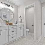 Elegant white bathroom vanity with modern cabinetry and mirror - premium cabinet solutions.