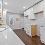 Bright white custom kitchen cabinets with gold hardware at Premium Cabinet Studio, Overland Park, Kansas.