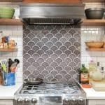 Sleek kitchen backsplash with modern scalloped tile design and premium cabinetry from Overland Park Cabinets.