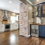 Custom kitchen cabinets with brick accent walls and modern setup, premium cabinet studio by Overland Park Cabinets.