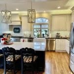 Sleek white kitchen cabinets with black accents and modern appliances, stylish kitchen design, premium cabinet studio, Overland Park Cabinets.