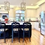 Stunning kitchen with custom white cabinets, stainless appliances, and a white island for perfect cooking and entertaining.