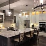 Sleek white and gray custom kitchen cabinets with marble island in premium cabinet studio.
