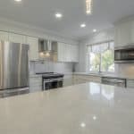 Elegant white kitchen cabinets with stainless steel appliances and modern design elements.