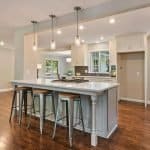 Modern kitchen with white cabinets and countertop island in contemporary design.