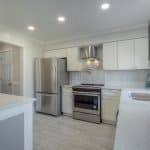 Stunning modern kitchen with custom cabinets and stainless steel appliances for premium cabinetry design.