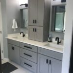 Modern gray bathroom vanity with dual sinks and ample storage from Premium Cabinet Studio.