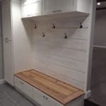 Sleek custom entryway bench with storage and hooks, premium cabinetry for functional home organization.