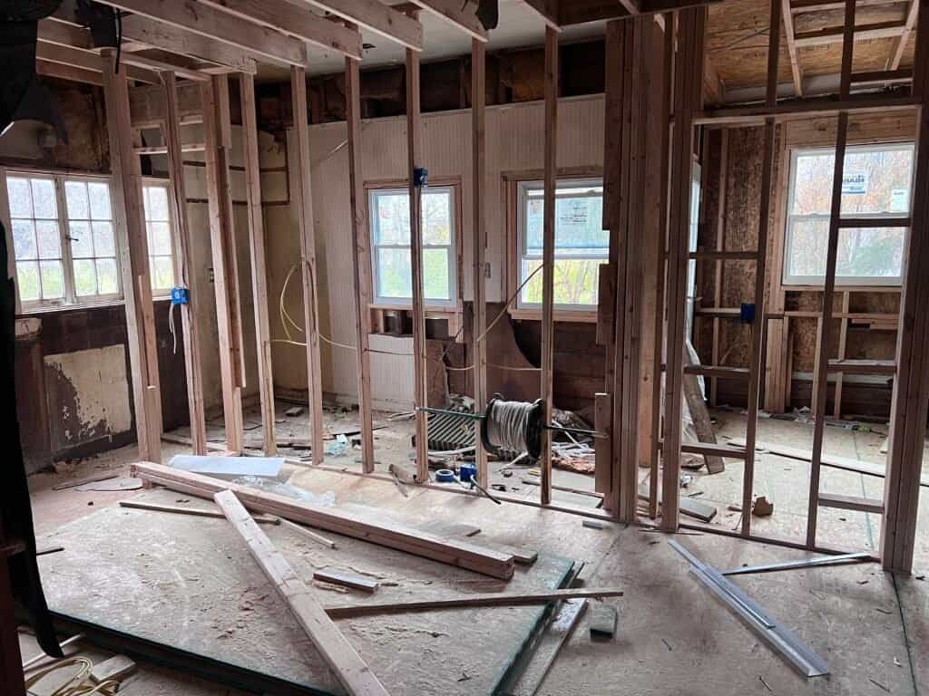 Kitchen demolition and framing before renovation, Merriam, KS Interior demo phase with new wall studs and electrical rewiring — historic home remodel in Merriam, KS