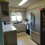Original outdated kitchen in Raytown, MO before remodel, with gray laminate cabinets, tile flooring, and dated finishes