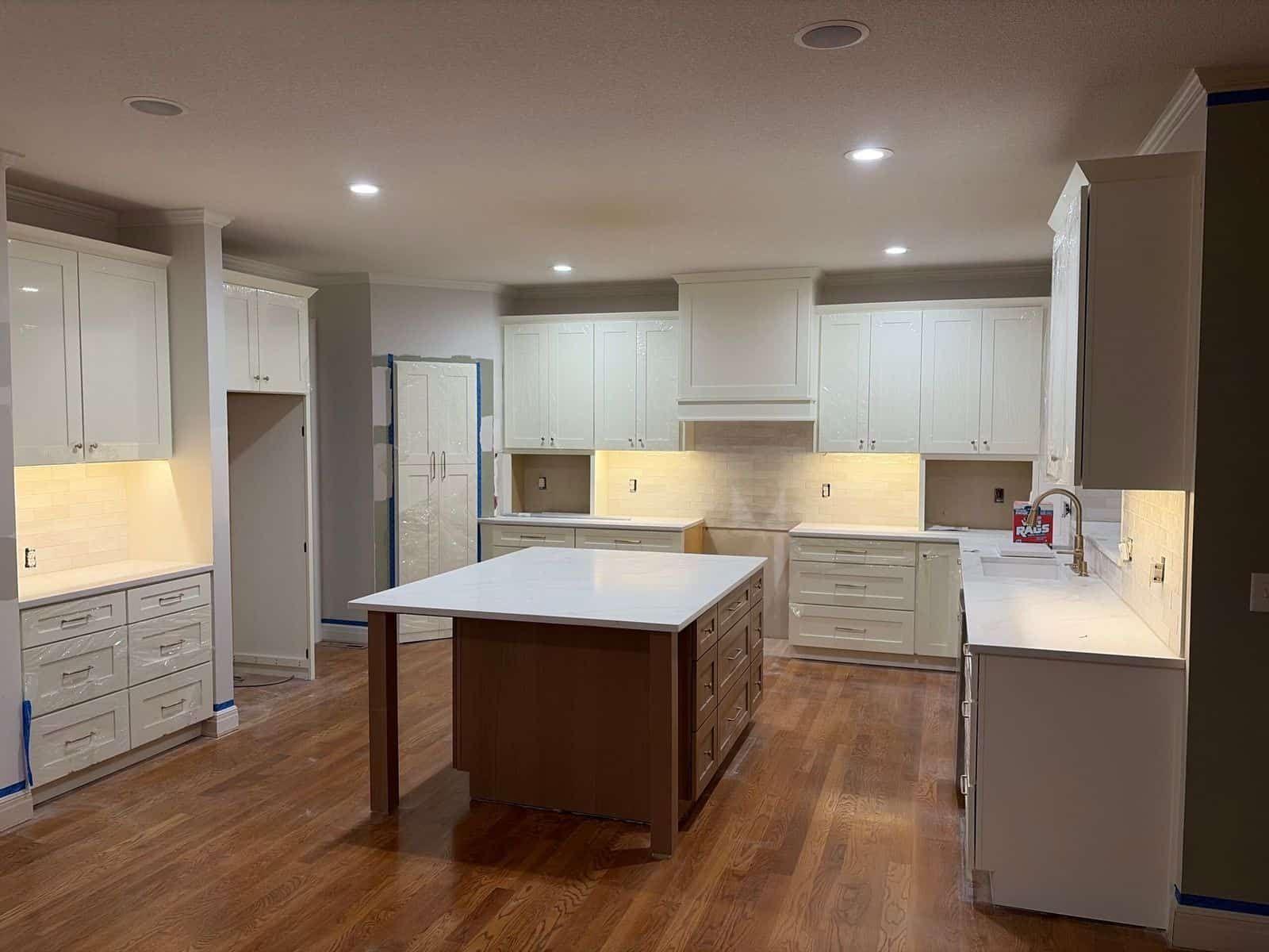 White shaker kitchen cabinets with contrasting wood island, kitchen remodel in Shawnee, KS
