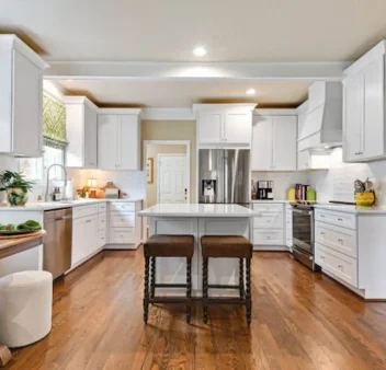 White shaker kitchen cabinets with island and hardwood floors-OverlandPark, KS kitchen remodel