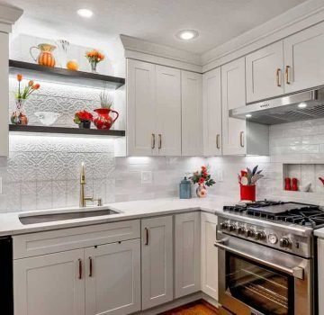 White shaker kitchen cabinets with floating shelves in Overland Park, KS.